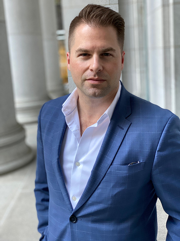 Brady Frey in a blue suit in front of the Bently Reserve building in San Francisco.